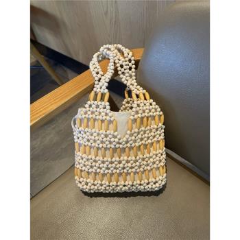小眾設計ins復古木珠水桶包手工編織鏤空包百搭單肩串珠手提包女