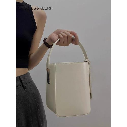 手提水桶包包女士2025新款夏季個性不規則斜挎包高級感白色抽帶包