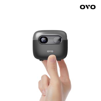 OVO 小蘋果投影機 U1-S 鈦銀黑 版，具備自動對焦功能，強化防熱設計，有效避免失焦，亮度再增強達 380LED流明。內含語音遙控器、硬殼包與伸縮腳架，輕巧便攜，適合居家或移動使用。支援 16:9 畫面比例，解析度達 854x480，內建喇叭，無需外接音響。電源為 110V，耗電低，重量僅 241g，是高價效比的微型投影機選擇。